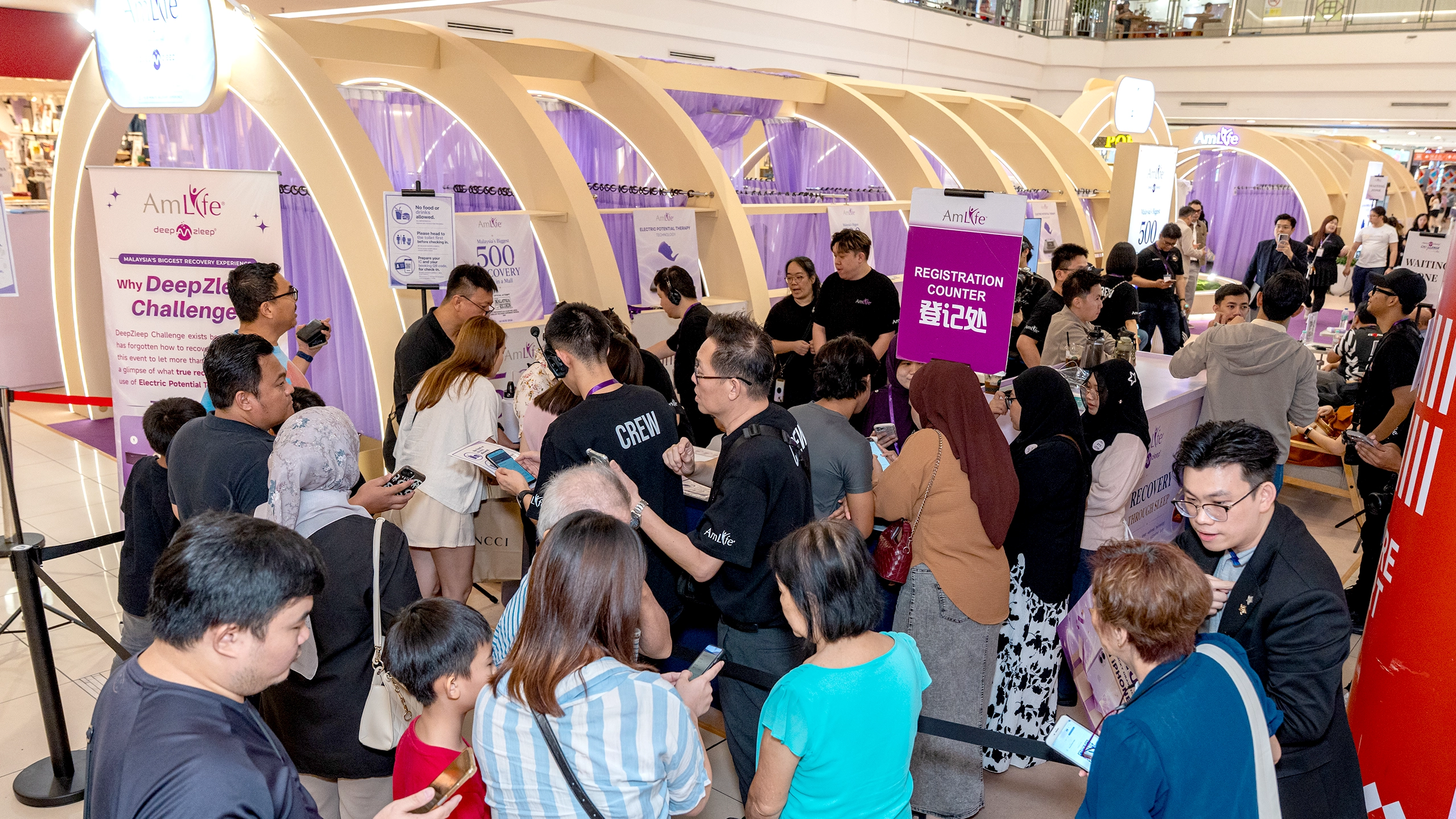 Participants queuing at the registration counter throughout the day.